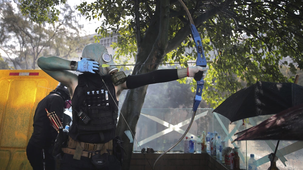 Hong Kong police break through barricades of a besieged university campus to arrest protesters - Featured Image